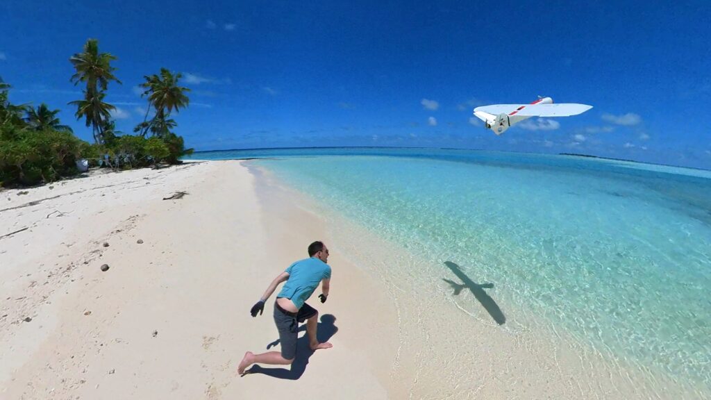 Man releasing a drone on a tropical beach.